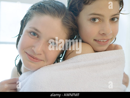 Two preteen girls sharing towel Stock Photo