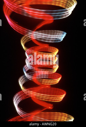 Spiraling light effects, one within the other, reds and yellows. Stock Photo
