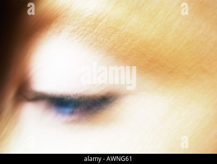 Woman's blue eye looking down, blurred close up. Stock Photo