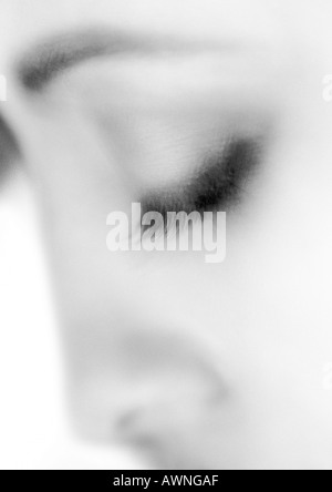 Woman's closed eye, blurry, close-up, black and white. Stock Photo