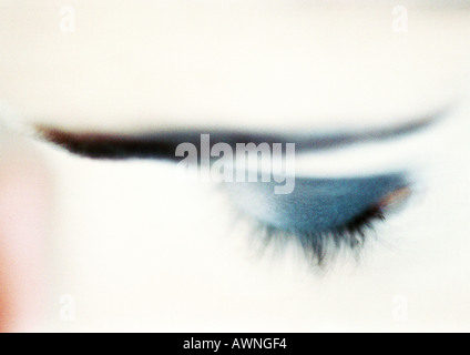 Woman's closed eye with blue eye shadow, close-up, high angle view, blurry. Stock Photo