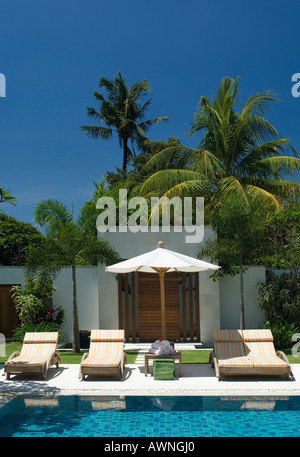 lounges poolside in luxury villa Stock Photo