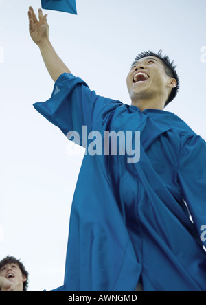 Male graduate throwing cap Stock Photo