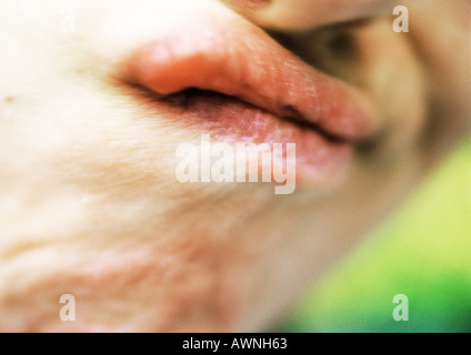 Woman's mouth making grimace, extreme close-up Stock Photo