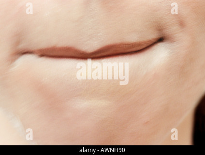Close up of woman's mouth with bottom lip tucked in. Stock Photo