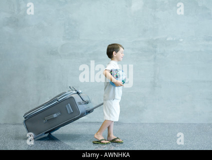 Boy with suitcase and globe Stock Photo