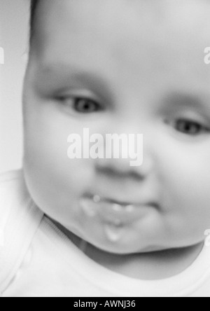 Baby drooling, blurred, close-up, B&W. Stock Photo