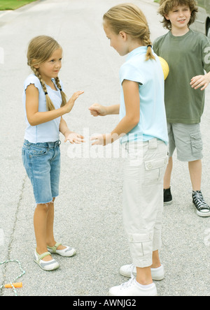 Suburban children playing in street Stock Photo