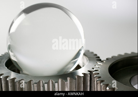 A crystal ball and machine cogs Stock Photo