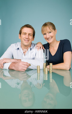 Couple with coins Stock Photo