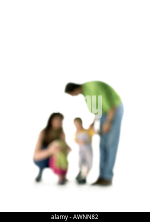 Silhouette of parents speaking to two children, on white background, defocused Stock Photo