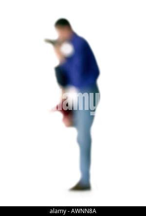 Silhouette of father holding child upside down, side view, on white background, defocused Stock Photo