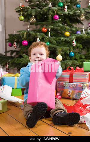 Boy opening christmas presents Stock Photo