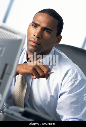 Businessman looking at computer monitor Stock Photo