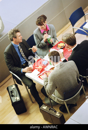 Business people having lunch on trays, elevated view Stock Photo