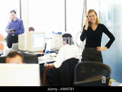 People using telephones and computers in office Stock Photo