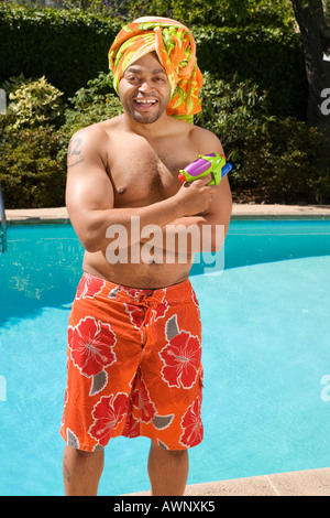 Man wearing towel turban by pool Stock Photo