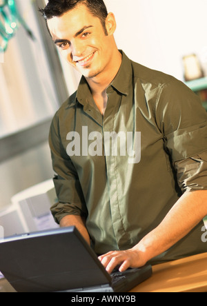 Man using laptop computer, portrait Stock Photo