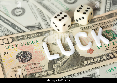 Dice on cash with "luck" lettering Stock Photo