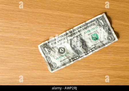 US one dollar bill laying on a table Stock Photo
