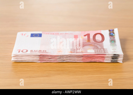 Stack of 10 Euro bills on a table Stock Photo