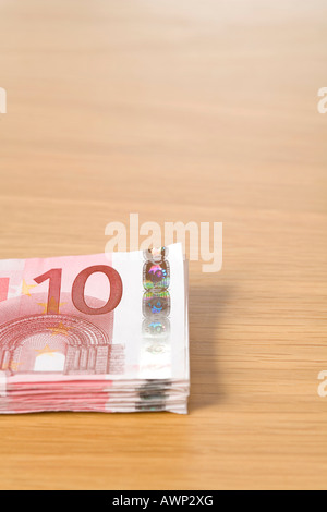 Stack of 10 Euro bills on a table Stock Photo