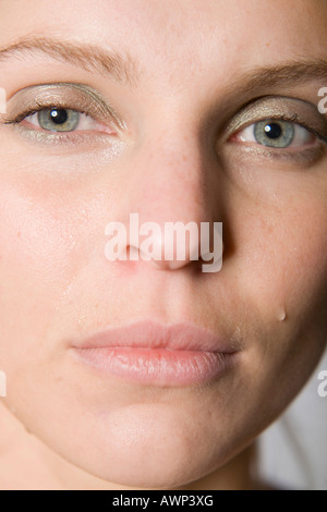 Young woman crying, tears streaming down her face Stock Photo