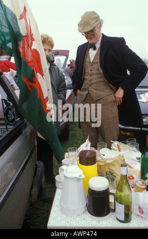 Twickenham rugby union ground, Welsh supporting couple picnic in car park before play starts London UK. Wales v England international 1985 1980s Stock Photo