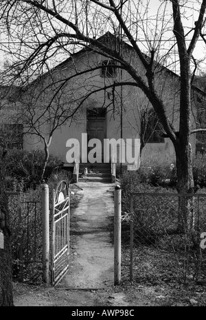 Owner occupied dwelling Old house Morshin cottage dog door entrance way road open poor Stock Photo