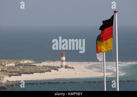 German flags, a sailboat and island dunes at deep-sea island Heligoland ...