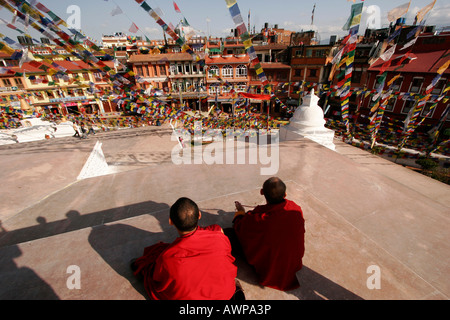 Buddhist monks at the stupa of Bodnath, a northeastern suburb of Kathmandu, Nepal, Asia Stock Photo