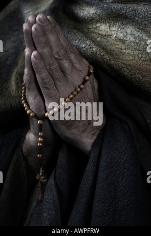 Hooded monk wearing habit, praying Stock Photo