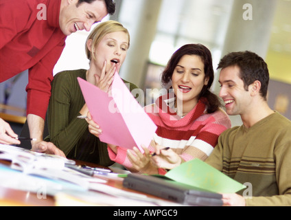 People examining documents, smiling Stock Photo