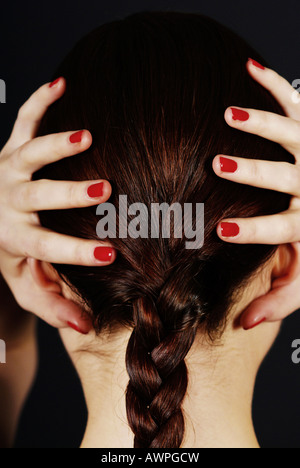 Young woman with hands on head Stock Photo