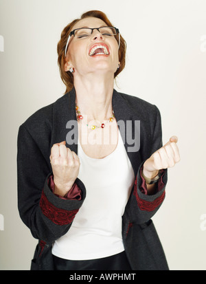 Businesswoman wearing eyeglasses happy about her success Stock Photo