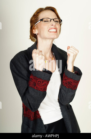 Businesswoman wearing eyeglasses happy about her success Stock Photo