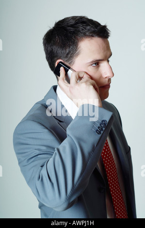 Young businessman making a call with his mobile phone Stock Photo