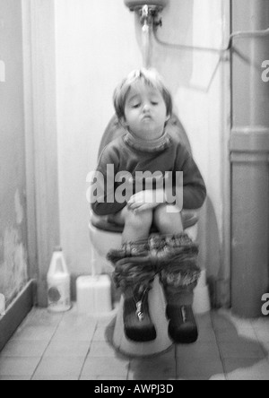 Girl sitting by the toilet bowl Stock Photo: 7537380 - Alamy