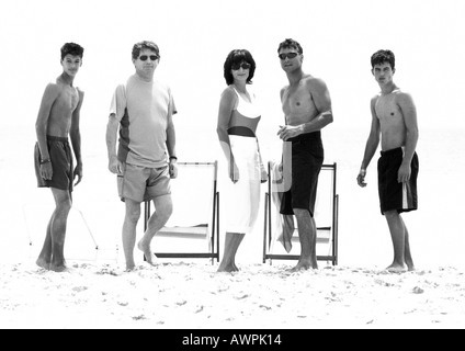 Adults standing on beach, b&w Stock Photo