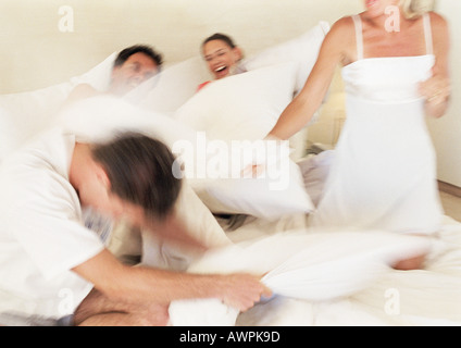 Family having pillow fight, blurred motion Stock Photo