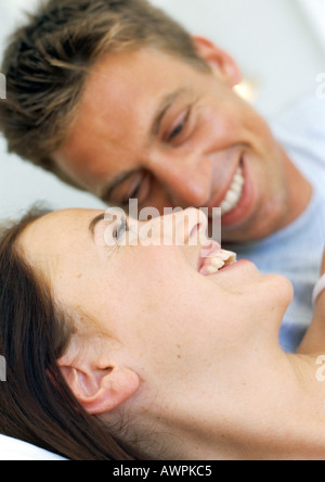 Couple resting in bed smiling, close-up Stock Photo