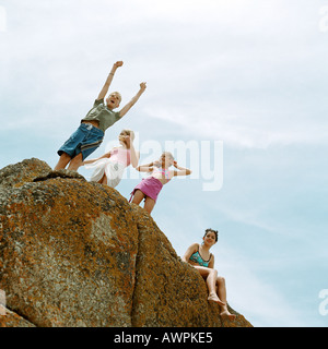 People standing on rock, low angle view Stock Photo