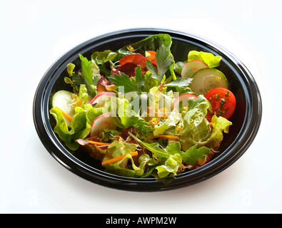 Mixed salad on a black plate Stock Photo