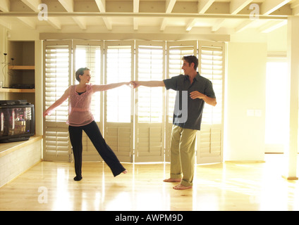 Couple dancing in room Stock Photo