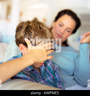 Woman and child with hand on head Stock Photo