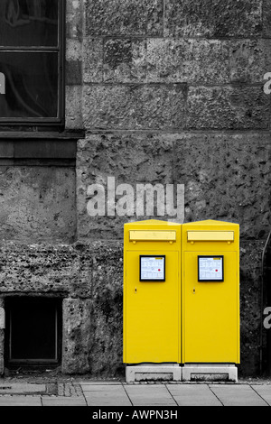 Two yellow mailboxes in front of a grey house wall, Augsburg, Bavaria, Germany, Europe Stock Photo