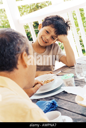 Father and son at table, close-up Stock Photo