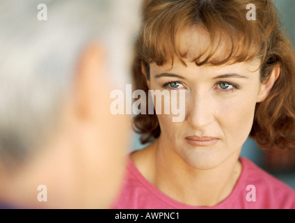 Woman looking at senior woman, close-up, blurred foreground Stock Photo