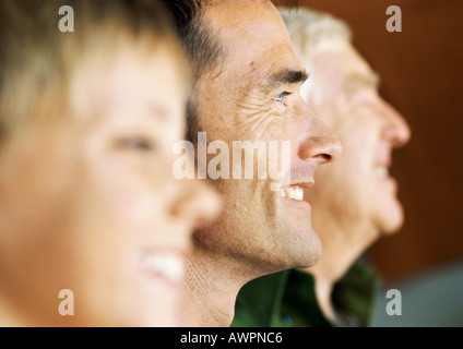 Grandfather, father and son, side view, focus on father Stock Photo