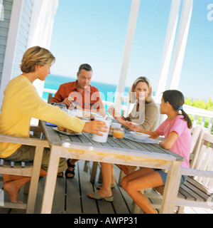 Couple and children having breakfast outside Stock Photo